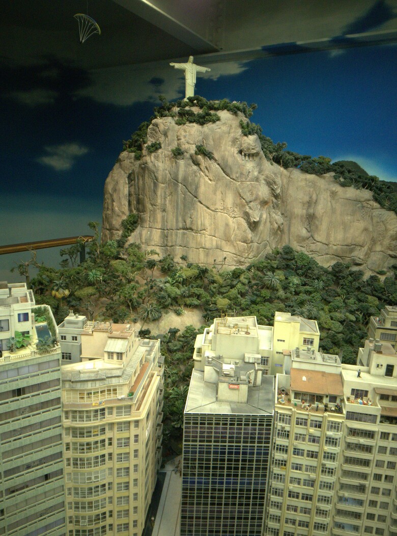 A view of miniature Rio de Janeiro inBrazil. A couple of high-story buildings in the front and the famous statue of 'Christ the Redeemer' on a mountain overlooking parts of the city. Miniaturwunderland